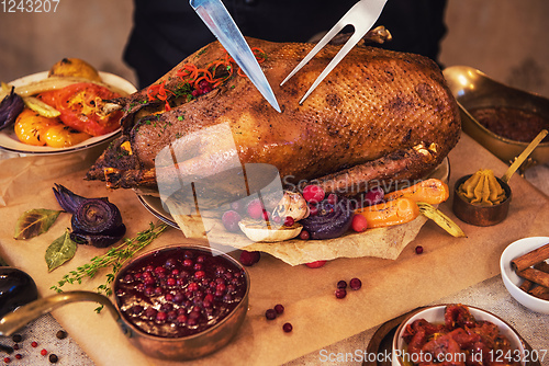 Image of Roasted goose with herbs berries and vegetables