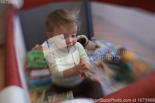 Image of cute little baby playing in mobile bed