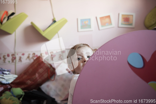 Image of cute little one year old baby and making first steps