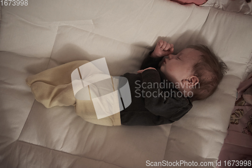 Image of One month newborn baby sleeping in bed