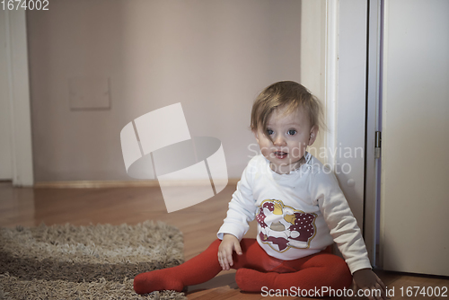 Image of cute little one year old baby and making first steps