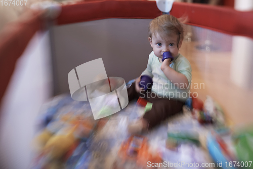 Image of cute little baby playing in mobile bed