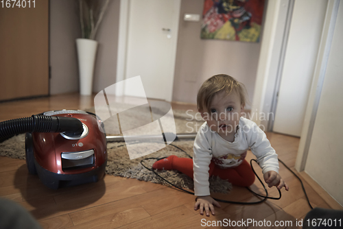 Image of cute little one year old baby and making first steps