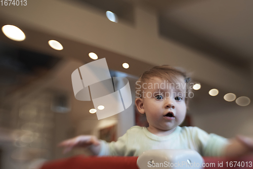 Image of cute little baby playing in mobile bed