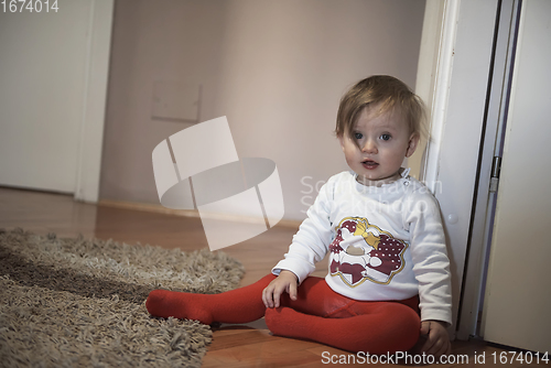 Image of cute little one year old baby and making first steps