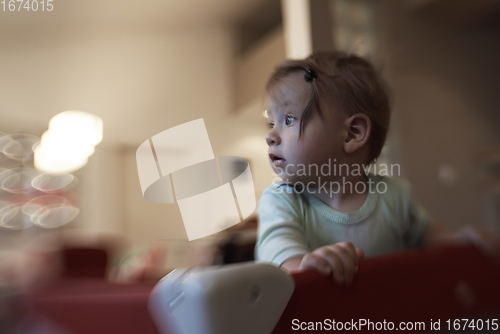 Image of cute little baby playing in mobile bed