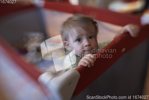 Image of cute little baby playing in mobile bed