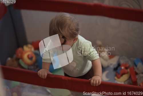 Image of cute little baby playing in mobile bed