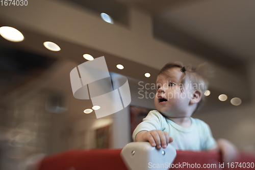 Image of cute little baby playing in mobile bed