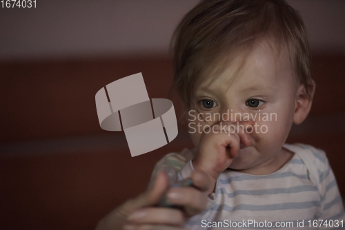 Image of cute little baby playing and making first steps