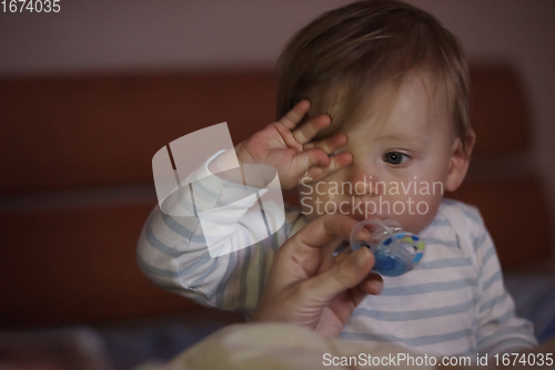 Image of cute little baby playing and making first steps