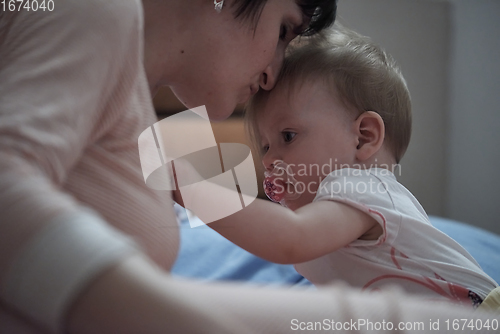 Image of mother is playing with baby at home