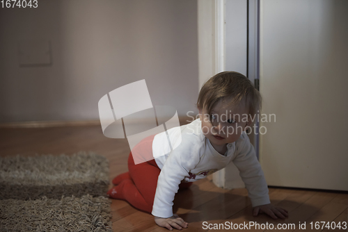 Image of cute little one year old baby and making first steps