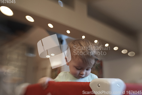 Image of cute little baby playing in mobile bed