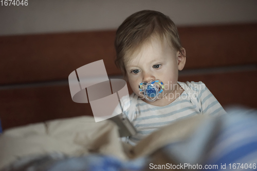 Image of cute little baby playing and making first steps