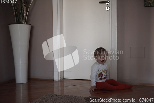 Image of cute little one year old baby and making first steps