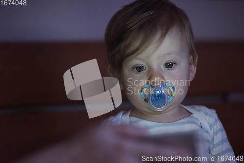 Image of cute little baby playing and making first steps