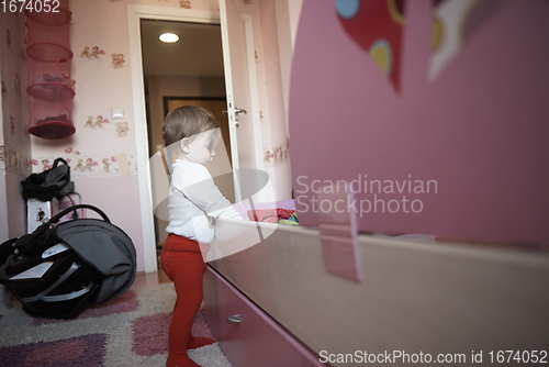 Image of cute little one year old baby and making first steps