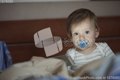 Image of cute little baby playing and making first steps