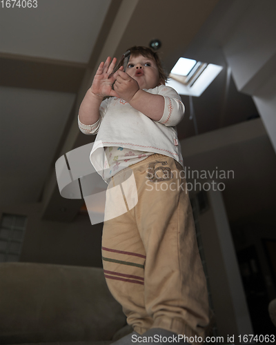 Image of Adorable cute beautiful little baby girl playing with toys at home