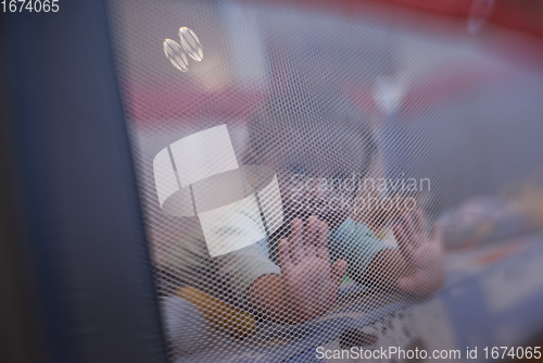 Image of cute little baby playing in mobile bed