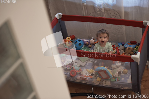 Image of cute little baby playing in mobile bed