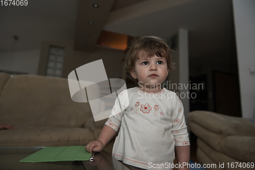 Image of Adorable cute beautiful little baby girl playing with toys at home