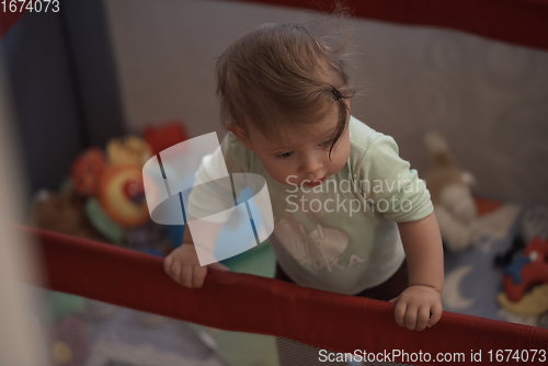 Image of cute little baby playing in mobile bed