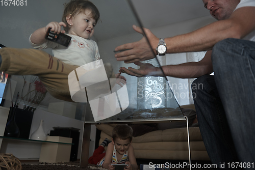 Image of Little child playing with sister at home