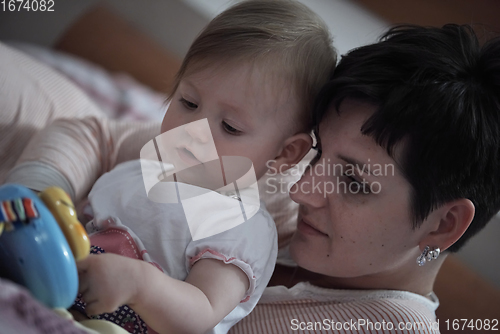 Image of mother is playing with baby at home