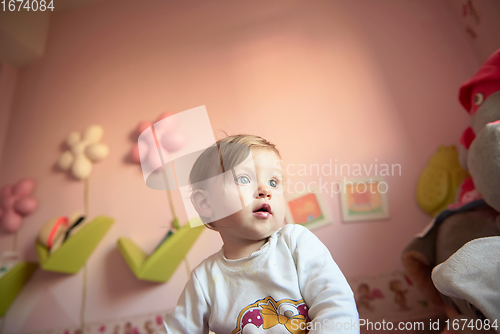 Image of cute little one year old baby and making first steps