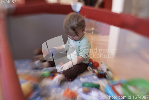 Image of cute little baby playing in mobile bed