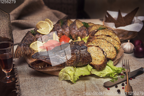 Image of Stuffed pike with vegetables and greens.