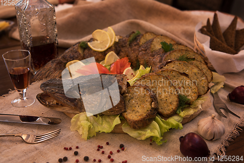 Image of Stuffed pike with vegetables and greens.