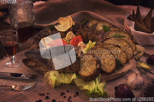 Image of Stuffed pike with vegetables and greens.