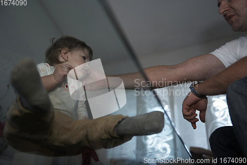 Image of Little child playing with sister at home