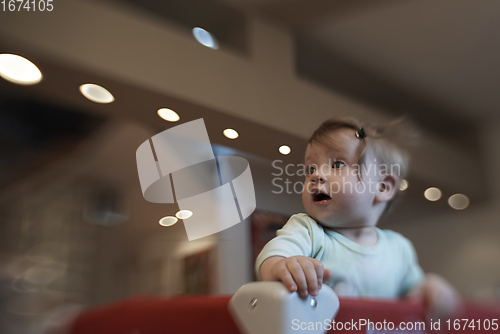 Image of cute little baby playing in mobile bed