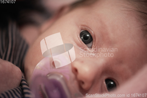 Image of One month newborn baby sleeping in bed