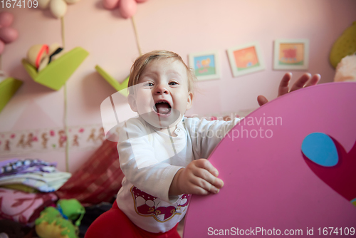 Image of cute little one year old baby and making first steps