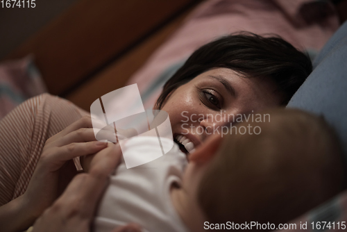 Image of mother is playing with baby at home