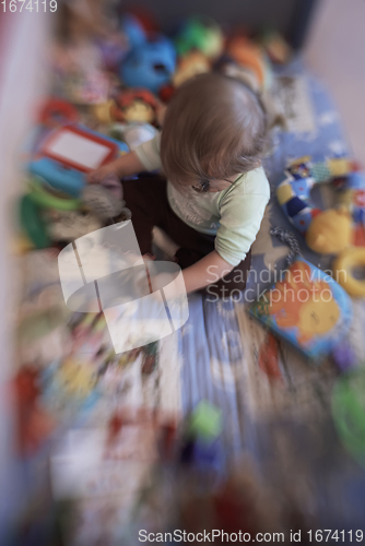 Image of cute little baby playing in mobile bed