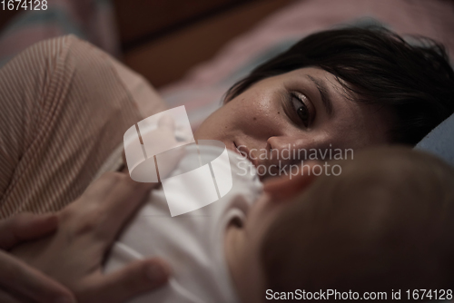 Image of mother is playing with baby at home