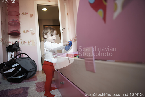 Image of cute little one year old baby and making first steps