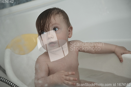 Image of cute little baby girl taking a bath