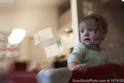 Image of cute little baby playing in mobile bed