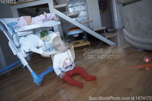 Image of cute little one year old baby and making first steps