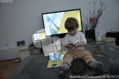 Image of Adorable cute beautiful little baby girl playing with toys at home