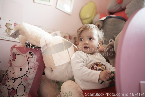 Image of cute little one year old baby and making first steps