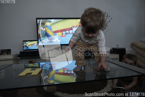 Image of cute little one year old baby and making first steps