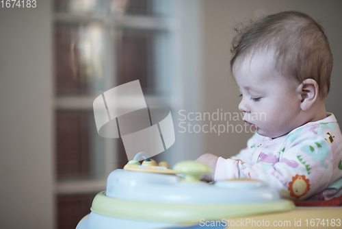 Image of baby learning to walk in walker